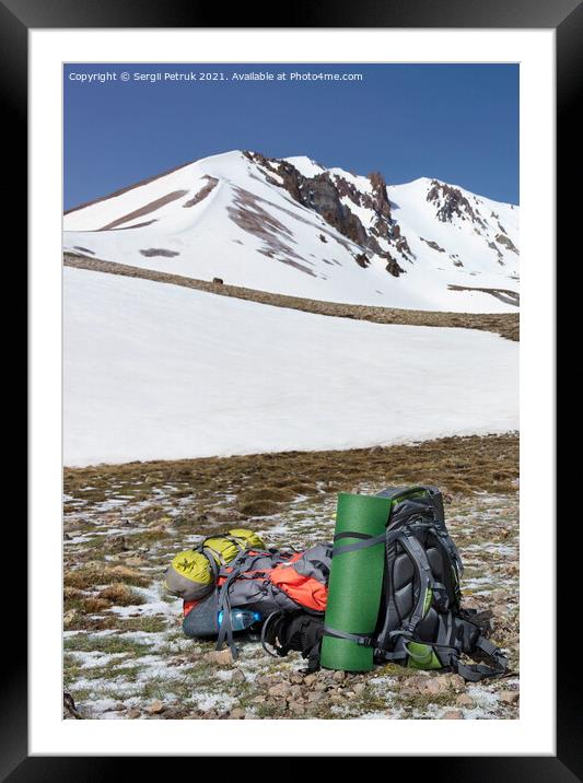 Camping equipment against the background of a snow-capped mountain and blue sky. Framed Mounted Print by Sergii Petruk