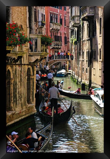 A Serene Gondola Ride Through Venice Framed Print by Roger Mechan