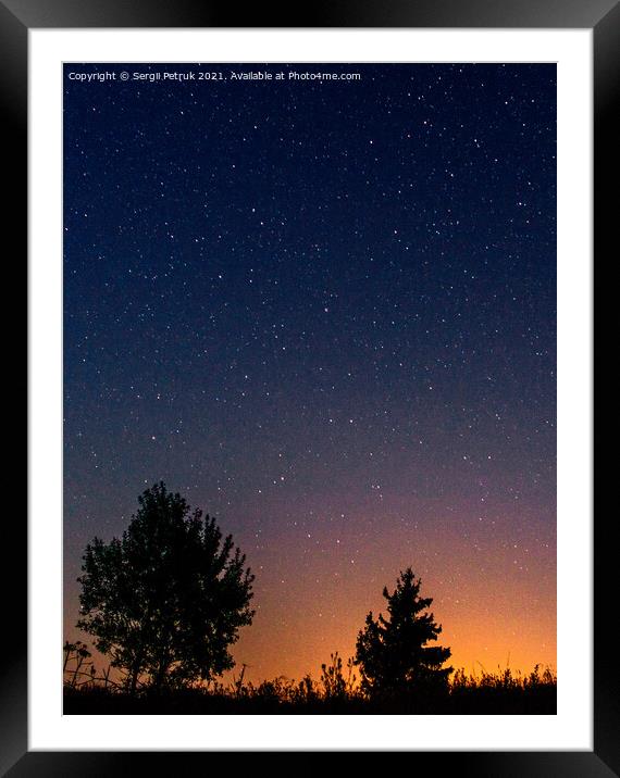 Silhouettes of low trees against the background of the night starry sky and the setting sun. Framed Mounted Print by Sergii Petruk