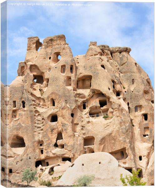 Ancient residential caves in the sandstone mountains of Cappadocia in Turkey. Canvas Print by Sergii Petruk