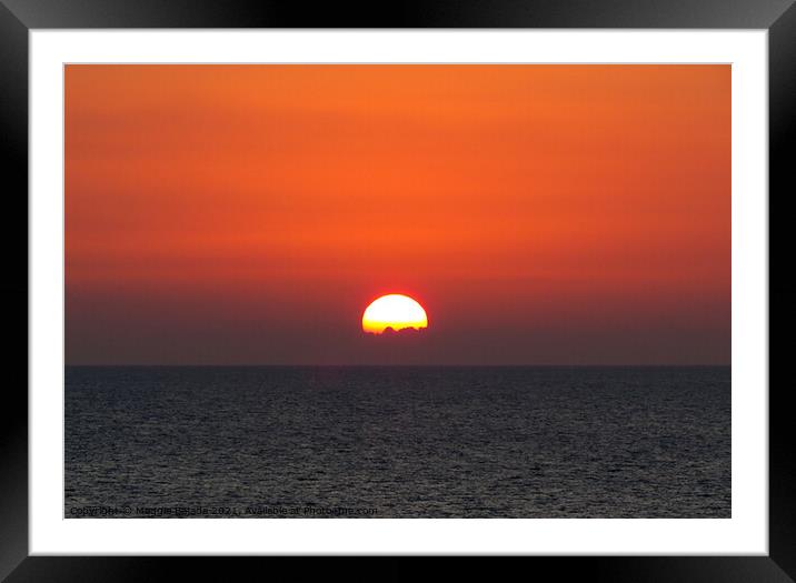 Sunset going down just below the horizon Framed Mounted Print by Maggie Bajada