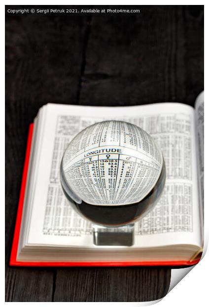Crystal ball and opened book of ephemeris on blurred black wooden background. Print by Sergii Petruk