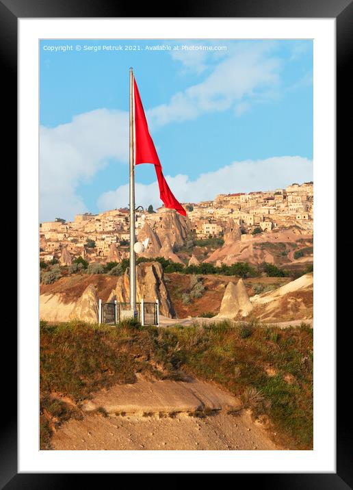 Turkey's large national flag towers over the ancient village of Uchisar in Cappadocia. Framed Mounted Print by Sergii Petruk