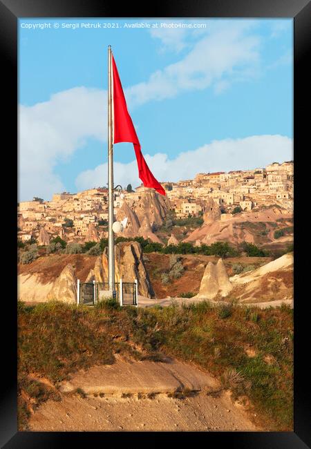 Turkey's large national flag towers over the ancient village of Uchisar in Cappadocia. Framed Print by Sergii Petruk