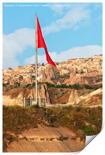 Turkey's large national flag towers over the ancient village of Uchisar in Cappadocia. Print by Sergii Petruk