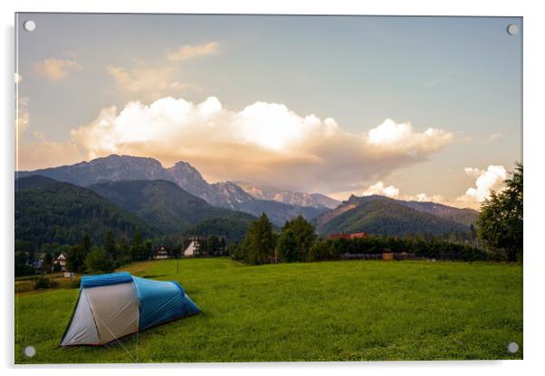 Camping tent put up on green grass meadow field against tatra mountains landscape during sunset sunrise and dramatic clouds, adventure in wild nature concept. Acrylic by Arpan Bhatia