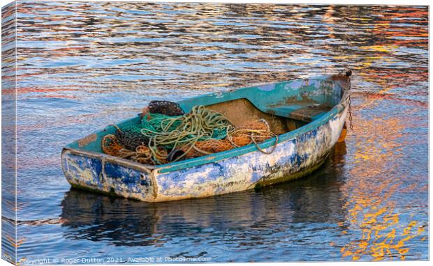 Enduring Beauty of a weather-worn boat Canvas Print by Roger Dutton