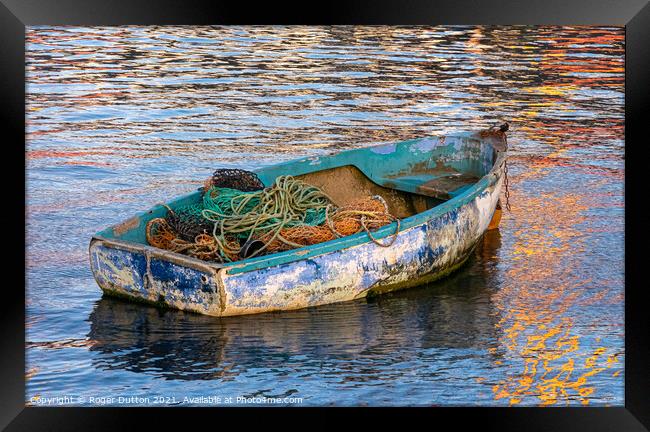 Enduring Beauty of a weather-worn boat Framed Print by Roger Dutton