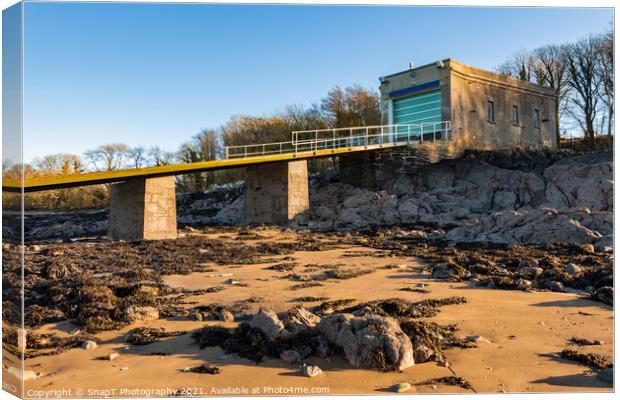 A coastal boat house and boat launch ramp slipway on a rocky beach in winter Canvas Print by SnapT Photography