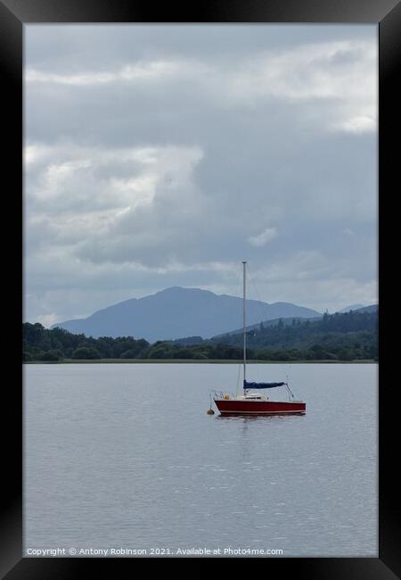 Little red sail boat moored on Loch Insh Framed Print by Antony Robinson