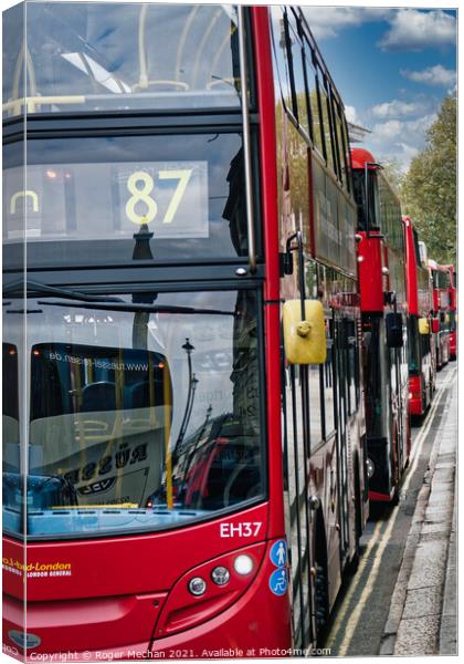 Endless Stream of Iconic Red Buses Canvas Print by Roger Mechan