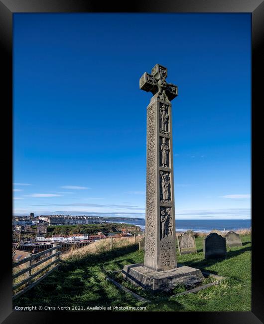 Celtic cross overlooking the seaside town of Whitby. Framed Print by Chris North