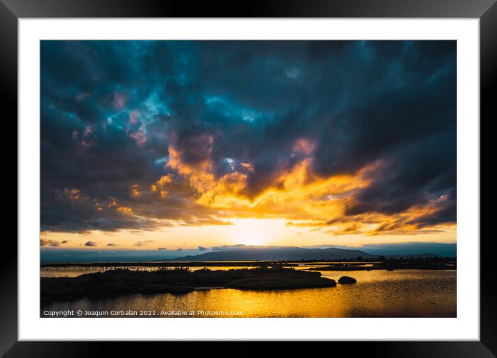 Beautiful sunset with the orb of the sun on the horizon among th Framed Mounted Print by Joaquin Corbalan