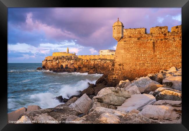 Peniche Fortress at sunset with beautiful golden light with sea waves crashing on the rocks, in Portugal Framed Print by Luis Pina