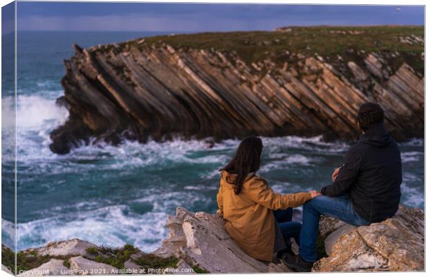 Couple caucasian female and male holding hands looking at cliff landscape with ocean waves in Baleal Island, Peniche, Portugal Canvas Print by Luis Pina