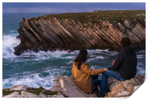 Couple caucasian female and male holding hands looking at cliff landscape with ocean waves in Baleal Island, Peniche, Portugal Print by Luis Pina