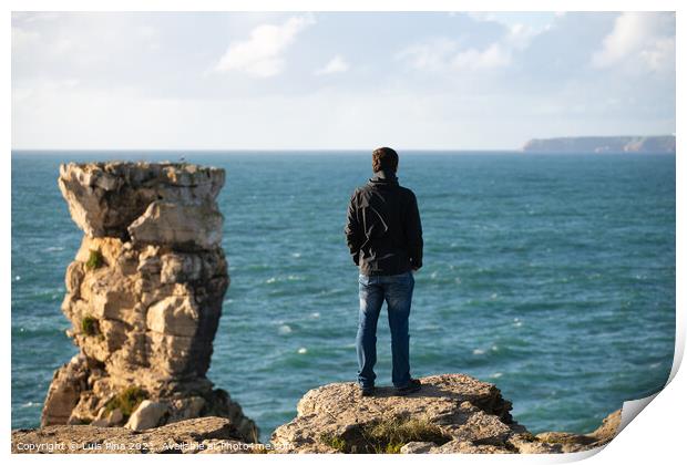 Caucasian man in sea cliffs landscape in Cabo Carvoeiro Cape looking at Berlengas Island, in Peniche, Portugal Print by Luis Pina