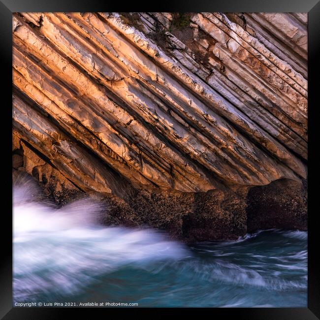 Beautiful schist cliff details in Baleal island with ocean waves crashing in Peniche, Portugal Framed Print by Luis Pina