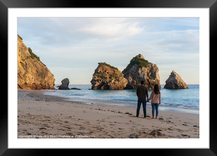 Couple holding hands on a wild empty beach in Ribeiro do Cavalo, Arrabida, Portugal Framed Mounted Print by Luis Pina