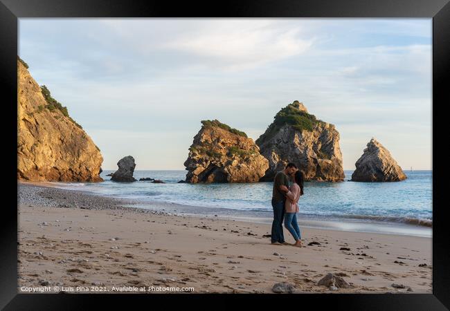 Couple kissing on a wild empty beach in Ribeiro do Cavalo, Arrabida, Portugal Framed Print by Luis Pina