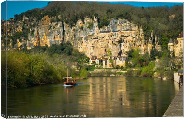 A sightseeing boat passes La Roque-Gageac Canvas Print by Chris Rose
