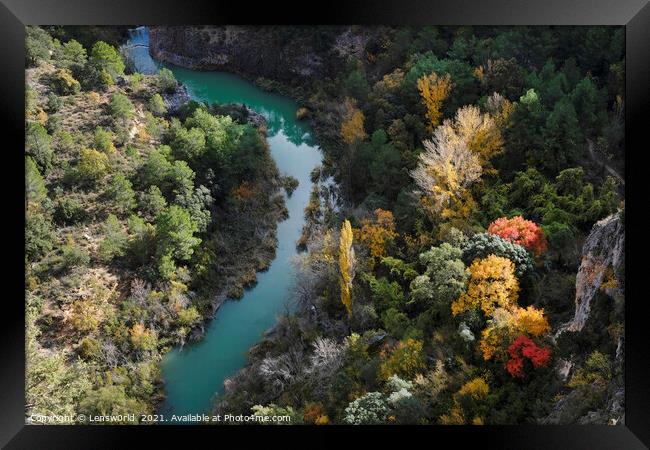 Colorful display of trees next to a river in fall season in Spain Framed Print by Lensw0rld 