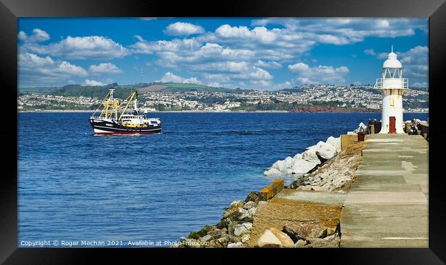 Trawler passing Brixham lighthouse  Framed Print by Roger Mechan