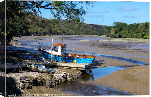 A small fishing boat moored while the tide is out Canvas Print by Joy Walker