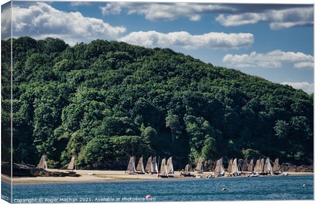 Serene Beach with Sailing Boats Canvas Print by Roger Mechan