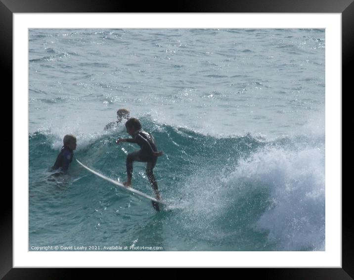 Boy surfing Framed Mounted Print by David Leahy
