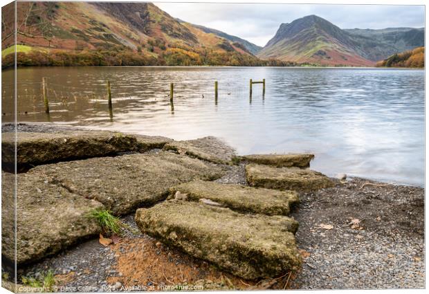 Stones n the Edge of Lake Buttermere in the Lake District in Cumbria, England Canvas Print by Dave Collins