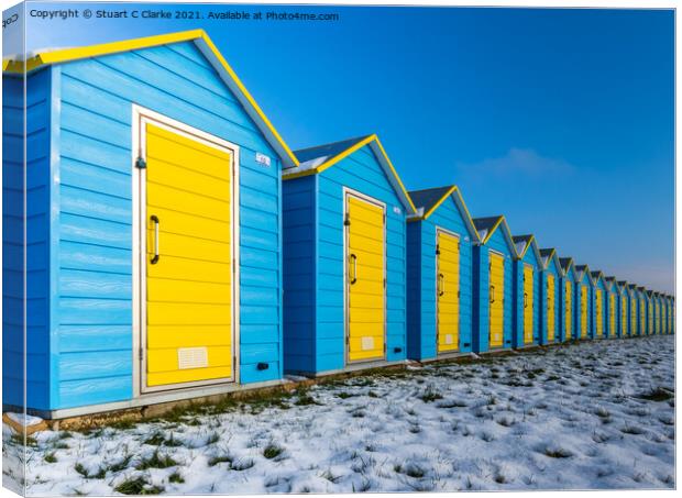 Beach huts in the snow Canvas Print by Stuart C Clarke