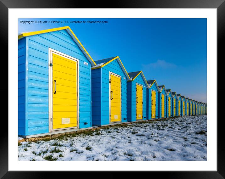 Beach huts in the snow Framed Mounted Print by Stuart C Clarke