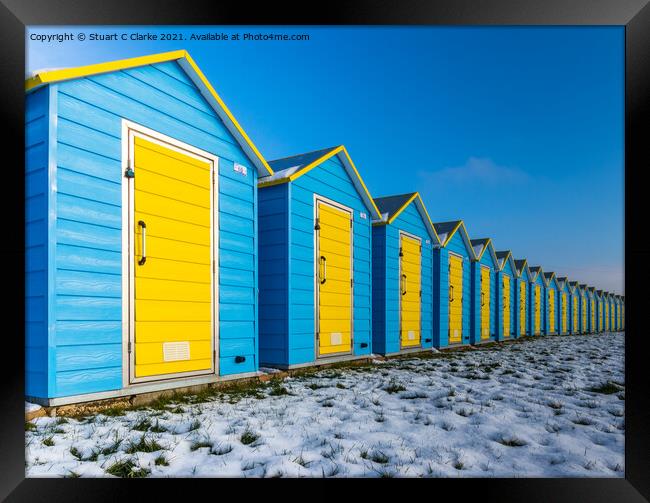 Beach huts in the snow Framed Print by Stuart C Clarke