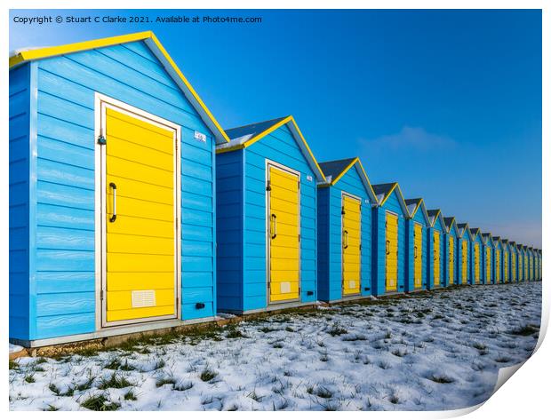 Beach huts in the snow Print by Stuart C Clarke
