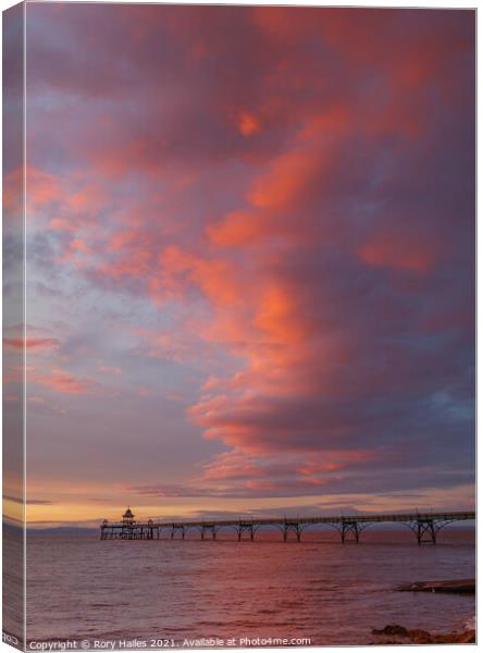Clevedon Pier with the cloud cover catching the colourful sunlight Canvas Print by Rory Hailes