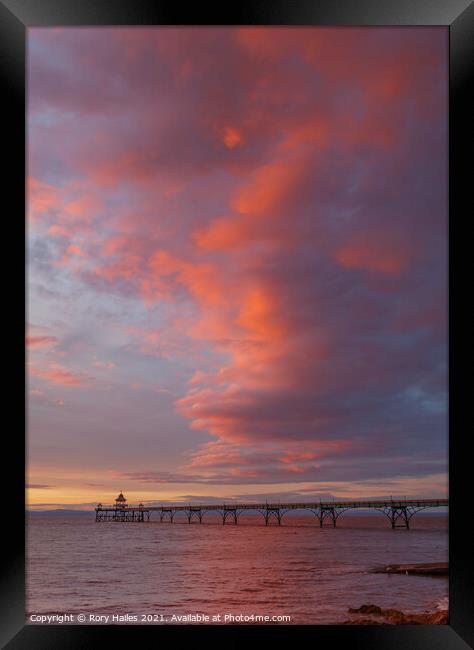 Clevedon Pier with the cloud cover catching the colourful sunlight Framed Print by Rory Hailes