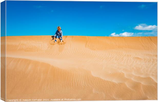 A child played on the sand dunes having fun with freedom, negati Canvas Print by Joaquin Corbalan