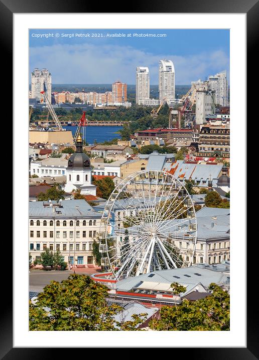 Ferris wheel and bell tower with copper roof and gilded dome in the old Podil district in Kyiv, cityscape on a summer day. Framed Mounted Print by Sergii Petruk