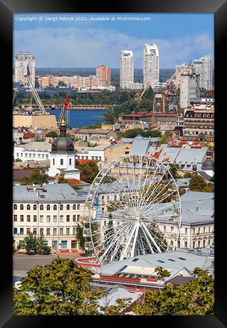 Ferris wheel and bell tower with copper roof and gilded dome in the old Podil district in Kyiv, cityscape on a summer day. Framed Print by Sergii Petruk