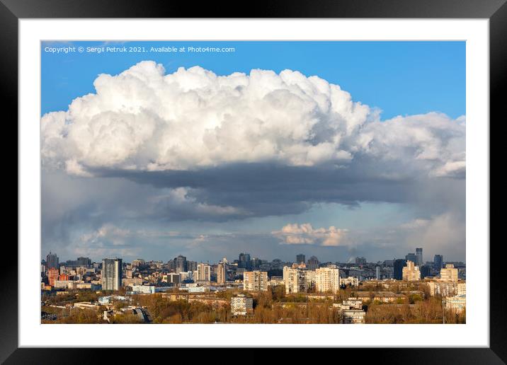 A large white-gray cloud hung over the city and was illuminated by the spring sunbeams. Framed Mounted Print by Sergii Petruk