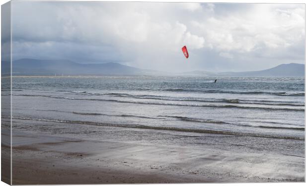 Kite surfer on the Anglesey coast Canvas Print by Jason Wells