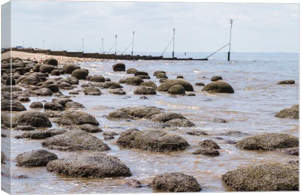 Waves lap up against the rock pools at Hunstanton beach Canvas Print by Jason Wells