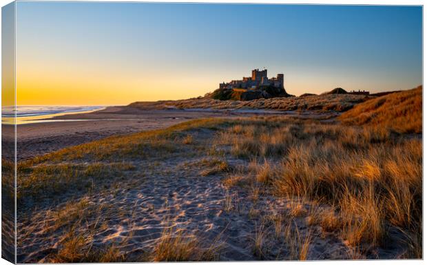 Sunrise at Bamburgh castle, Northumberland Canvas Print by Michael Brookes