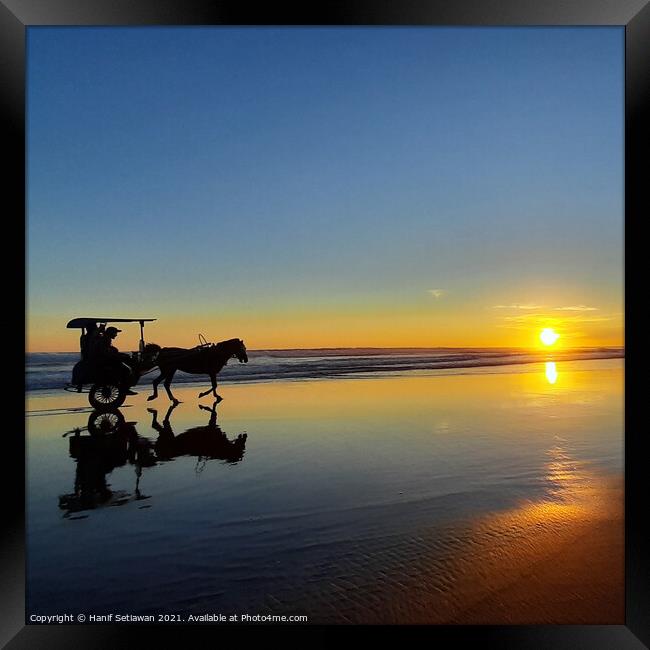Horse-drawn carriage on sunset beach in square 1 Framed Print by Hanif Setiawan