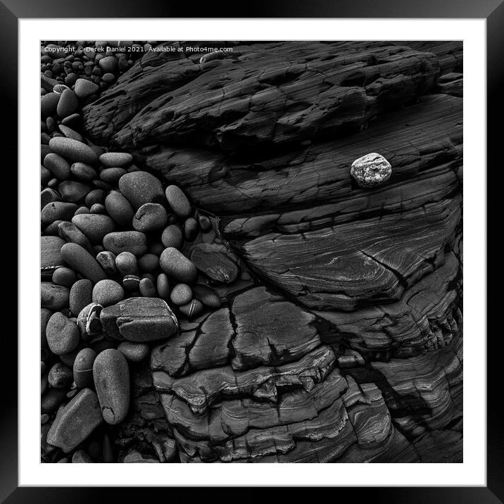Rocks on the beach at Sandymouth (mono) Framed Mounted Print by Derek Daniel