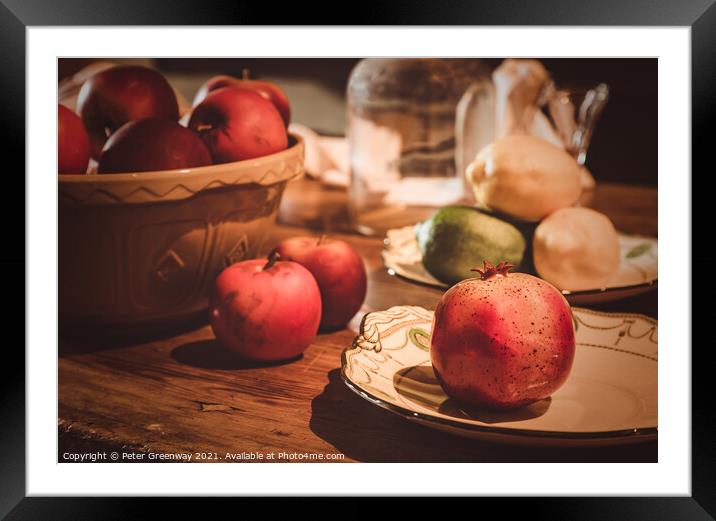 Festive Pomegranate & English Apples On A Rustic Kitchen Table Framed Mounted Print by Peter Greenway