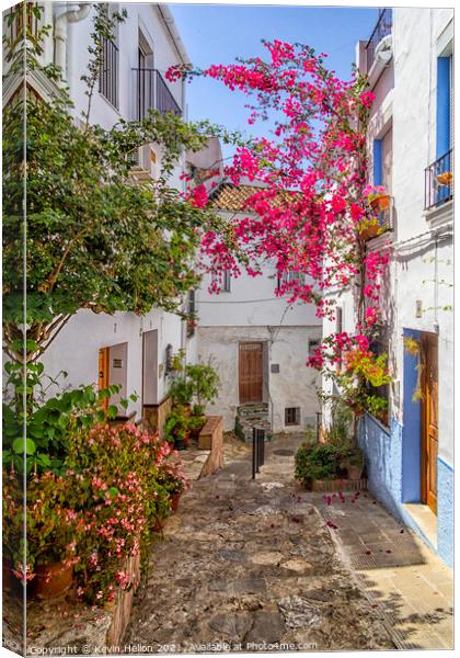 Narrow, hilly street in Ubrique Canvas Print by Kevin Hellon