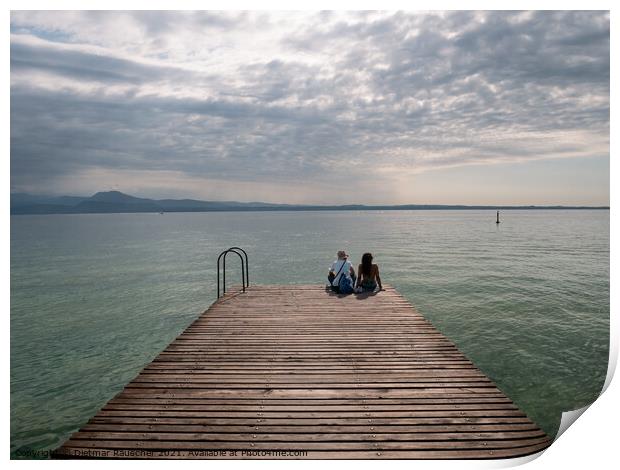 Tourists Sitting on jetty on Lake Garda in Sirmione Print by Dietmar Rauscher