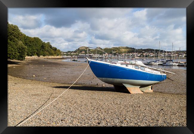 Boat beached at low tide Framed Print by Jason Wells